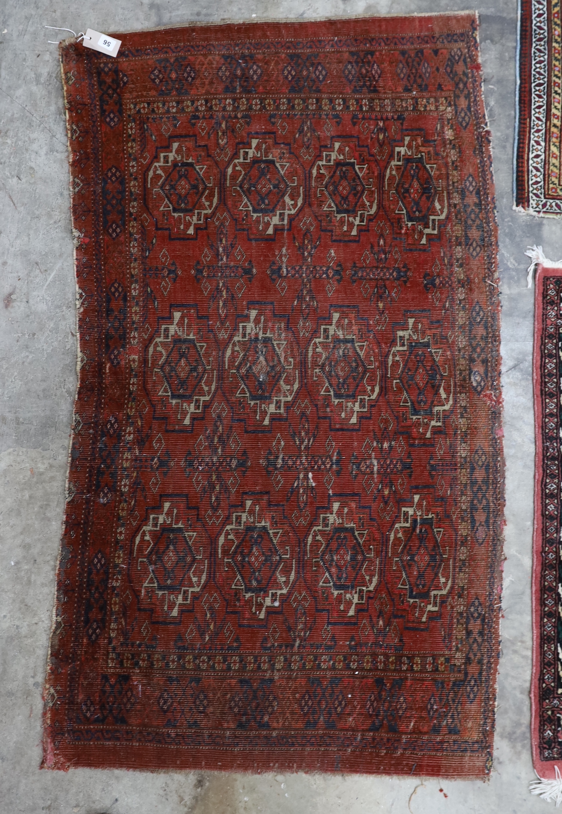 An antique Tekke red ground rug, a Caucasian rug and three others, largest 194 x 138cm